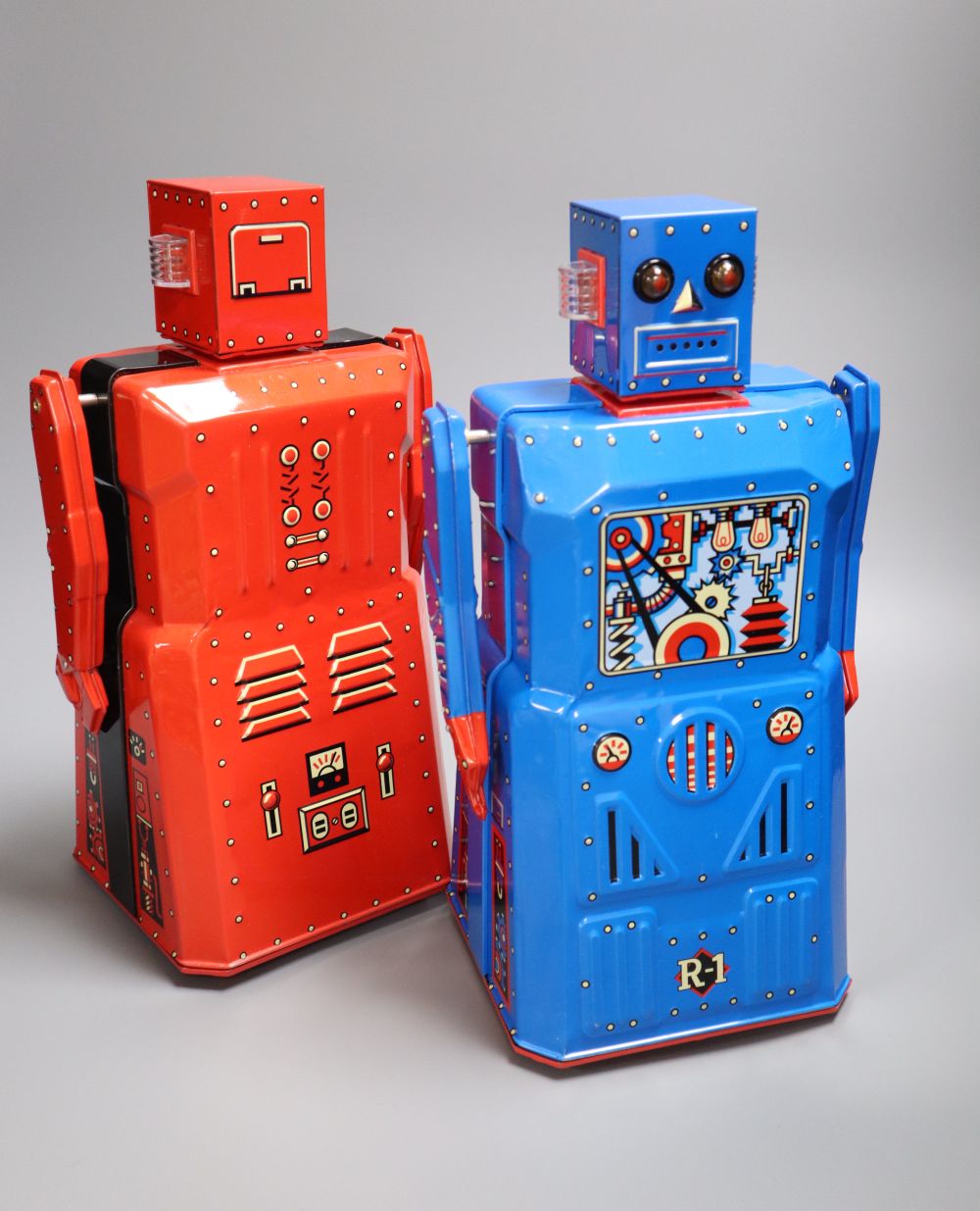 Rocket USA, a rare limited edition 2001 Red R-1 Robot with Black Band, No. 15/34 and a blue version of the R-1 Robot,